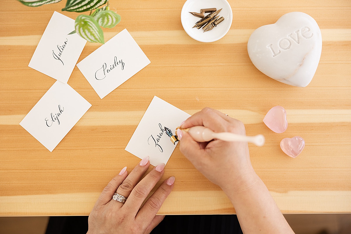 women writing name notes captured during her brand photo shoots