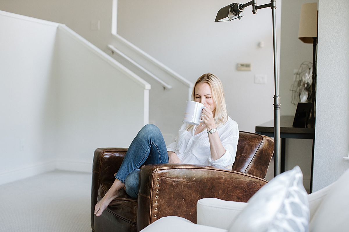 women drinking coffee while sitting on couch captured by a San Francisco Brand Photographer
