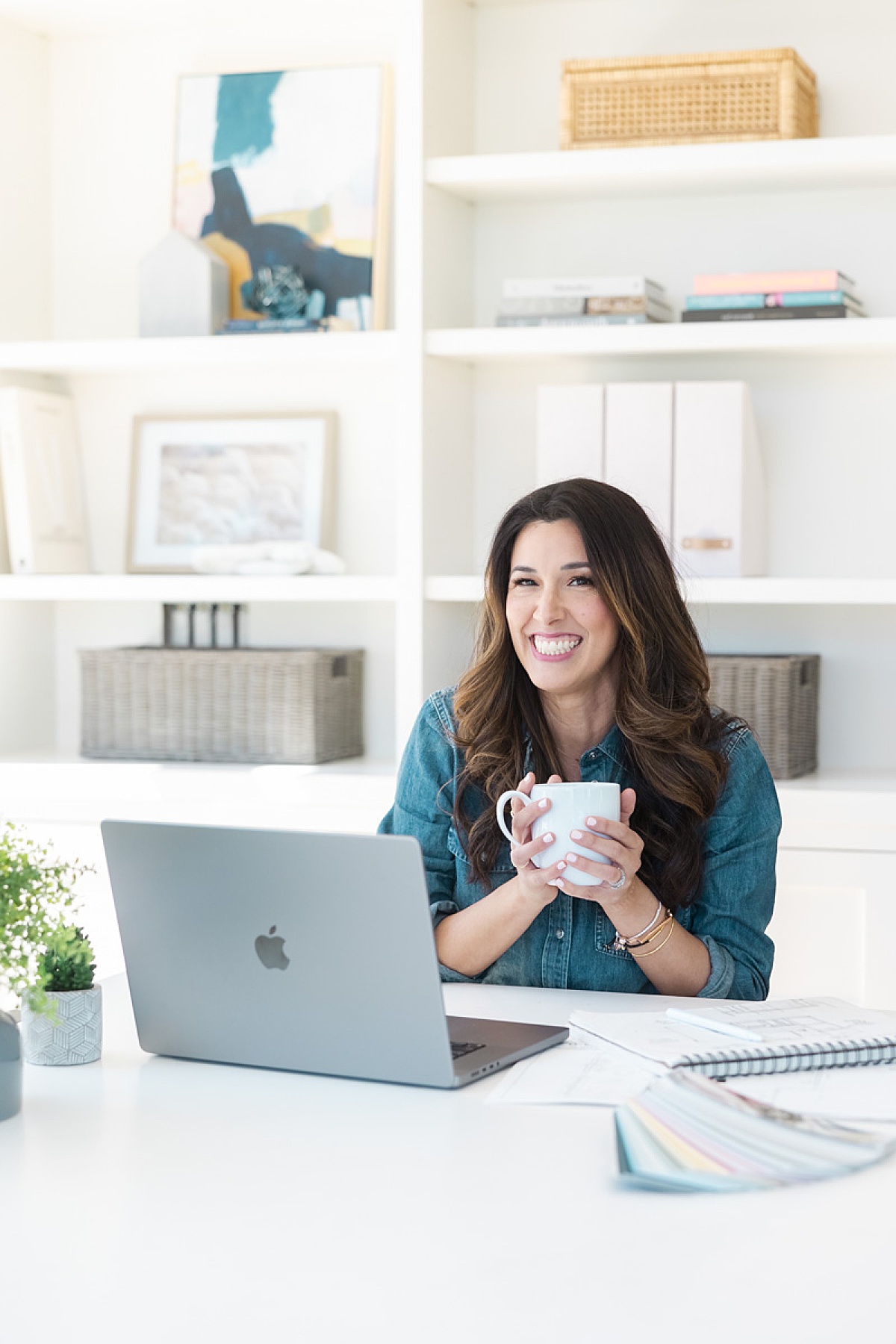 interior designer holding coffee mug at computer