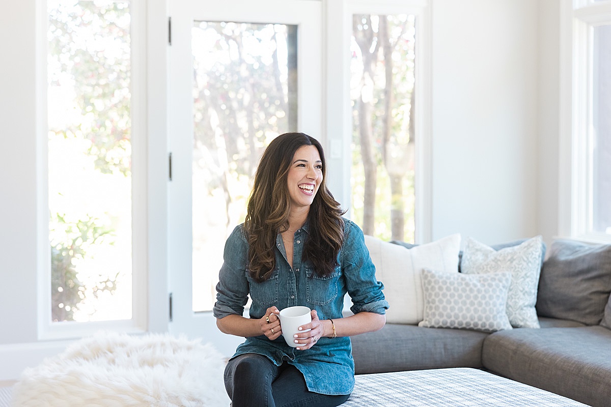 women sitting in living room holding mug during her Shoot with a San Francisco Brand Photographer