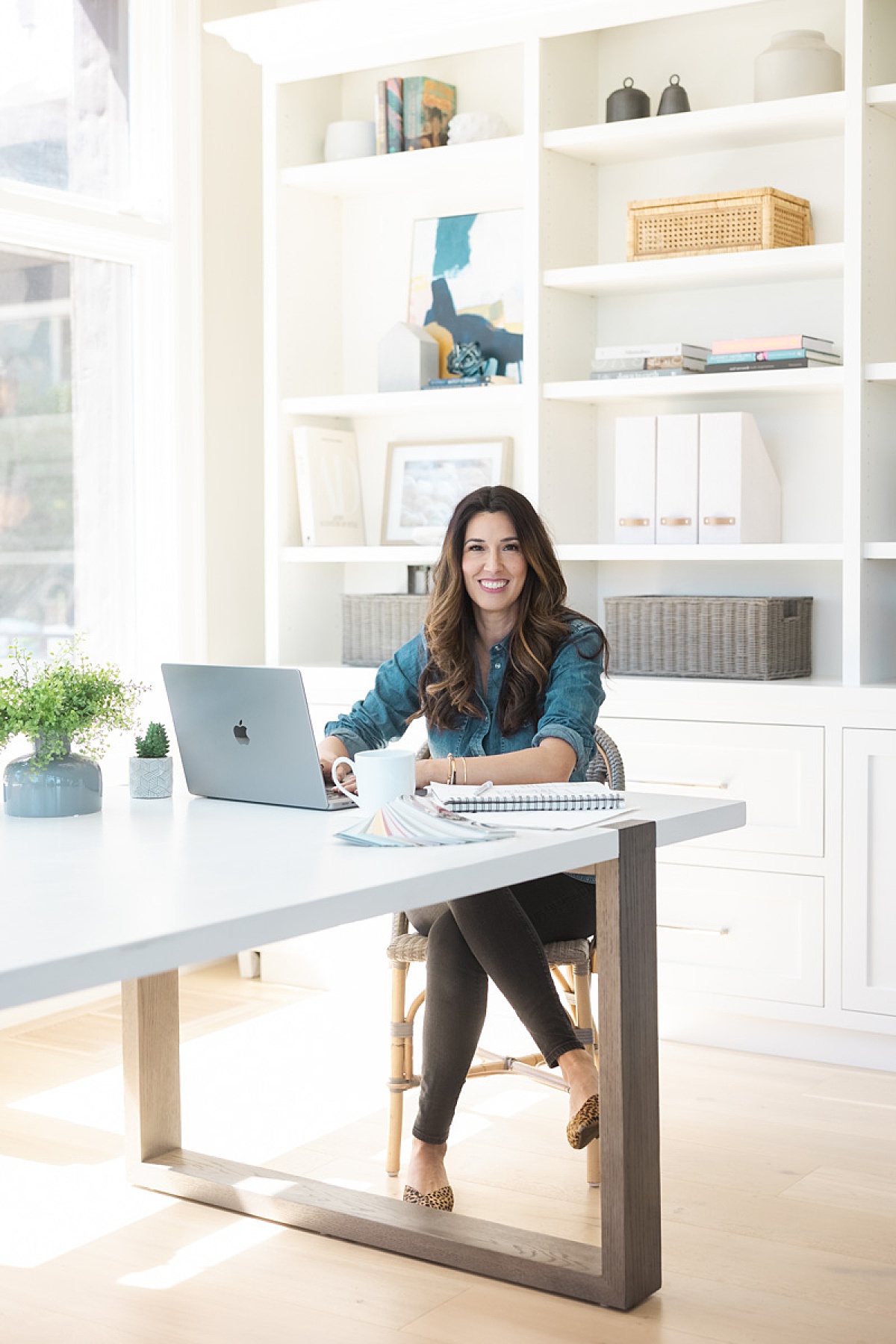 women sitting at desk working while Amy Thompson Photography takes photos 