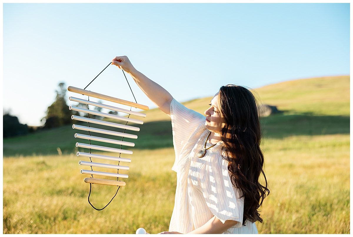 Woman sits in a field for a Brand photographer