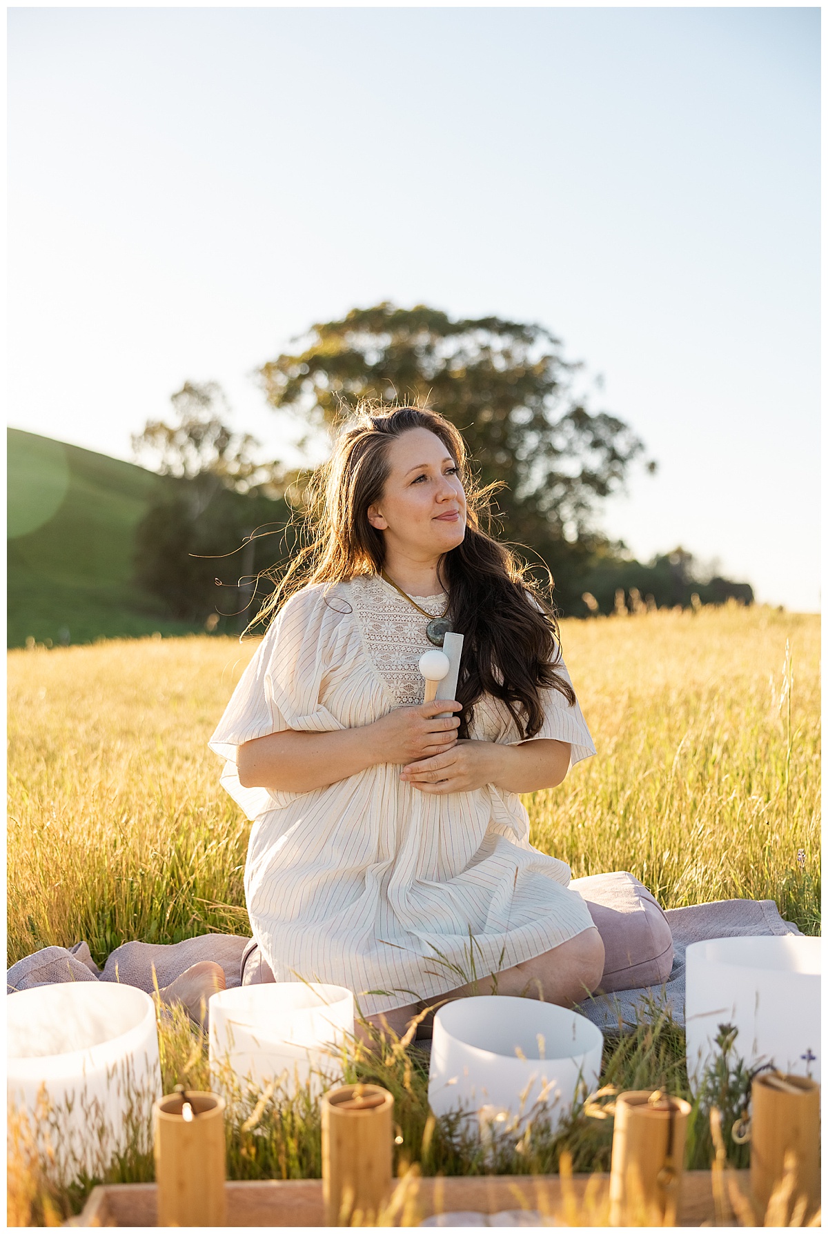 Adult sits down in an open field for a Brand photographer